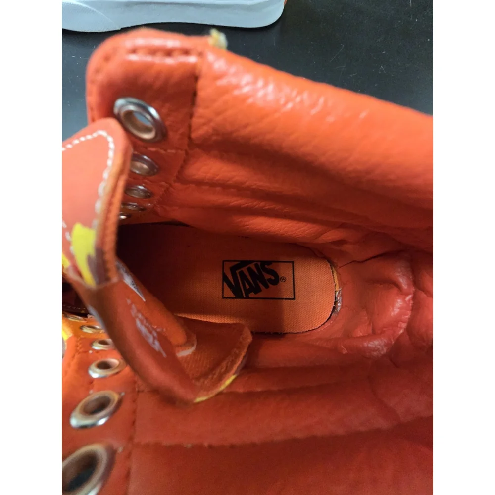 Vans Sk8-Hi high-top sneakers in an orange and yellow camouflage